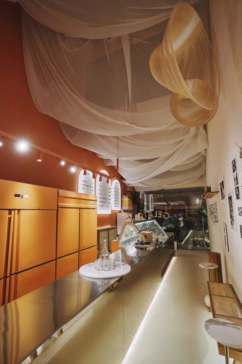 The orange open-kitchen corridor of the boutique, almost finished